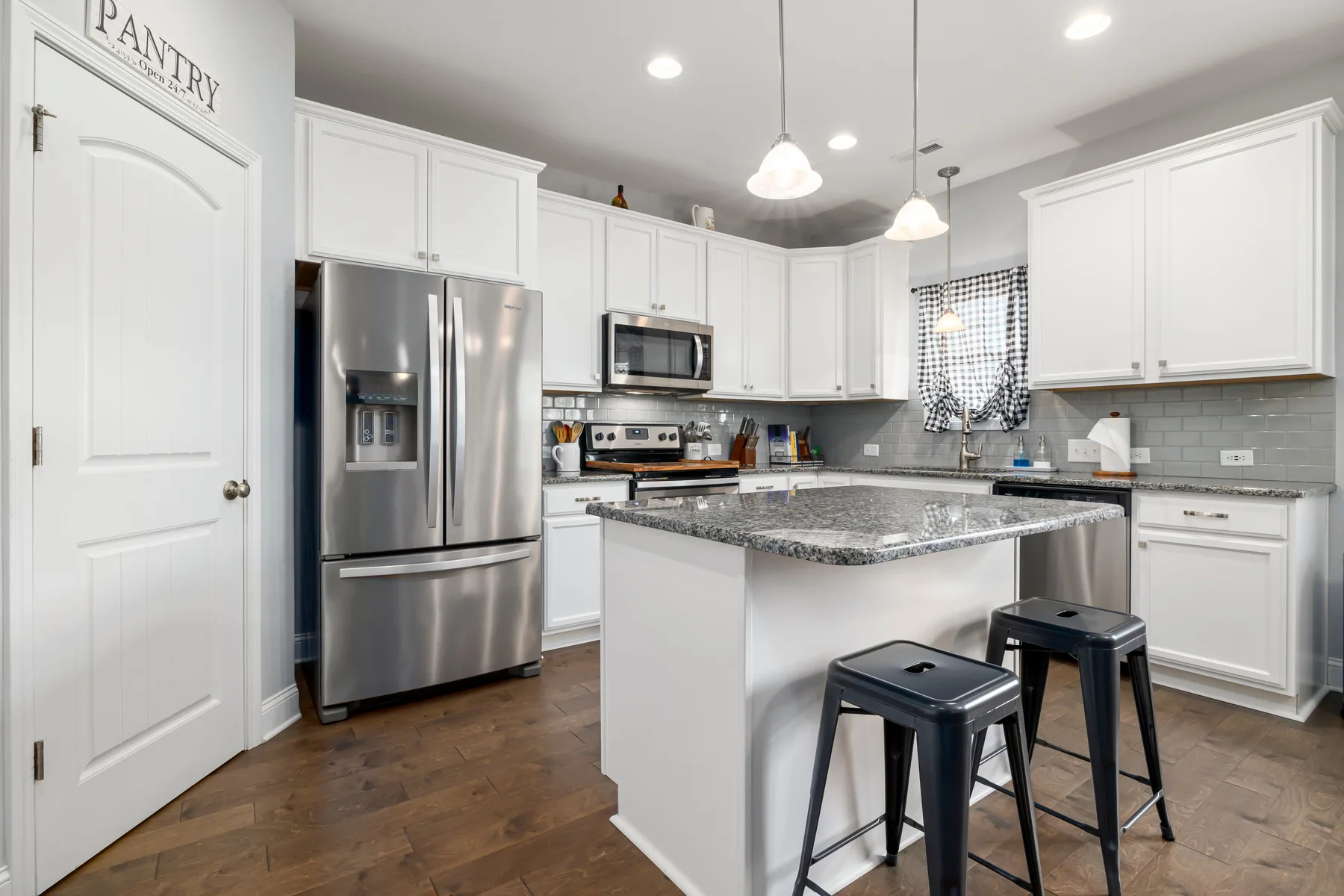 Bright modern kitchen with island and stainless-steel appliances
